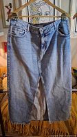 Front view of long blue denim skirt showing slit and overall condition