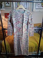 Front view of full-length multicolor knit sweater on hanger