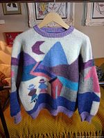Front view of handmade wool sweater showing scenic intarsia design