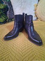 Front view of both boots showing leather texture and toe shape