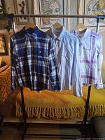 Full view of three shirts on rack
