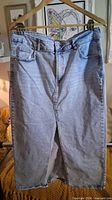 Full view of front of light blue denim skirt on hanger