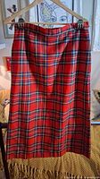 Front view of red plaid skirt hanging