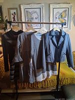 Full view of four garments on rack
