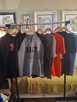 All five tops hanging on rack