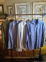 All four shirts hanging on garment rack