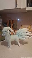 Left side view of Ninetales plush showing tails and mane