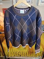 Front view of navy and brown argyle Scotch & Soda sweater on hanger