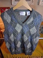 Full view of argyle wool vest front on hanger