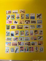 Overview of all 50 Cuban stamps arranged on yellow background