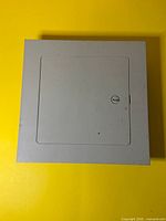 Front view of closed grey metal access door