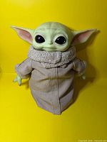 Front view of Grogu plush wearing robe