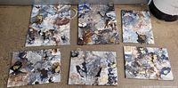 Six abstract mixed-media canvas paintings laid out on floor