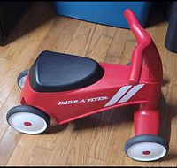 Side view of red Radio Flyer Scoot About Sport ride-on
