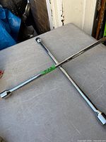 Full view of chrome cross lug wrench
