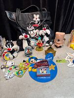 Overall view showing tote bag, plush Sylvester, figures, keychains and Disney items