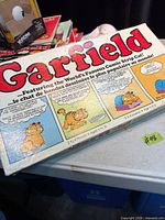 Top of original Garfield board game box with bilingual comic artwork