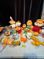 Group shot of all Garfield plush toys and balls on tabletop