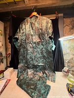 Front view of tunic and pants hung together showing overall design and pattern