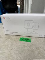 Front of sealed Teckin TC100 camera box showing product details and 2-pack indication