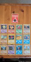 Overview of all 13 Pokémon cards laid out on table
