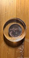 Front view of acrylic disc showing 1967 Canada cent reverse with rock dove