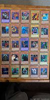 All 20 Yu-Gi-Oh cards laid out in sleeves/toploaders