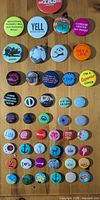 Full set of assorted pinback buttons displayed on tabletop