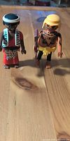Both Playmobil figures standing on table