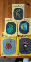 All five sealed embroidered denim patches displayed
