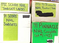 Four labeled card storage boxes showing set and subset titles