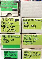 Stacked boxes with hand-written labels identifying each card set