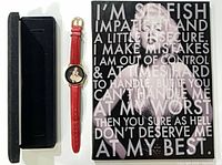Lot overview: watch box, red-strap watch, framed canvas art