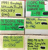 Six labeled card storage boxes showing set names and card ranges