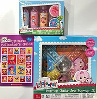 Front view showing all three Lalaloopsy items: bath set, guide book, pop-up game