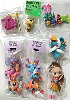Grouped shot showing all bagged pets, bee figure with comb, clothing pieces, Blythe doll