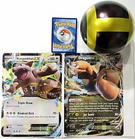 Kangaskhan-EX and Dragonite-EX jumbo cards beside standard card for scale, Great Ball replica at top right