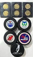 Overview of 6 coins in holders and 5 pucks