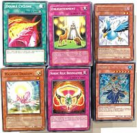 Six sleeved Yu-Gi-Oh cards showing variety of Monster, Spell and Trap types