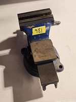 Top view of blue 5-inch bench vise showing jaws and paint wear