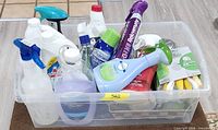 Top view of tote showing assorted cleaners and sponges