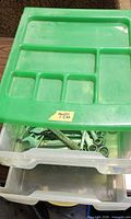 green-topped plastic organizer closed, showing drawer with wrenches