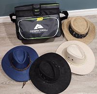 Cooler closed beside four hats displaying exterior materials and colours
