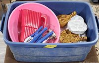 All items grouped in blue tote: mixing bowl, mandoline, mason jar, jar openers, escargot plates