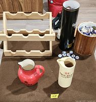 Overall lot with pitchers, wine rack, bucket, caps and tube