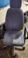 Front view of blue fabric office chair showing headrest, backrest and seat