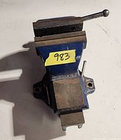 Top view of blue cast iron bench vise