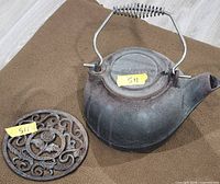kettle and trivet full view showing rust and design