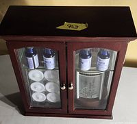 Front view of mahogany cabinet with glass doors showing contents