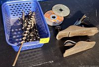 Lot overview with basket of auger bits, sanding discs, and two hand planes